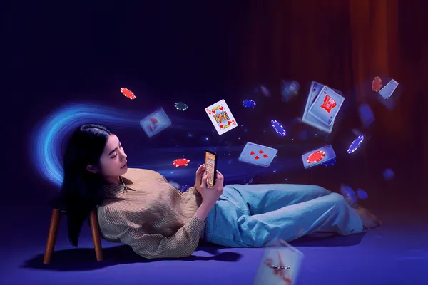 A young woman relaxing with her phone while dynamic casino elements float around her, illustrating the smooth mobile experience offered by the DBJL app.