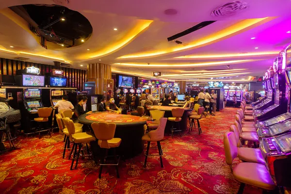 A close-up shot of golden coins falling around a spinning roulette wheel, representing immersive casino action at DBJL.