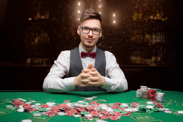A confident dealer surrounded by casino chips inviting players to access their DBJL account, reflecting quick and easy login options.